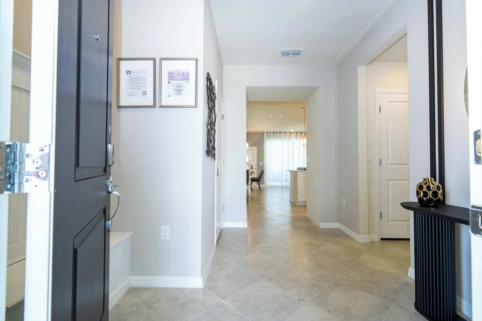 Enjoy a bright, airy entryway with elegant tile floors and contemporary touches, offering a warm welcome as you step into this spacious retreat.