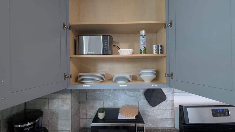 Find everything in a glance. Clearly labeled dinnerware and toaster keep group meals simple before MetLife Stadium events.