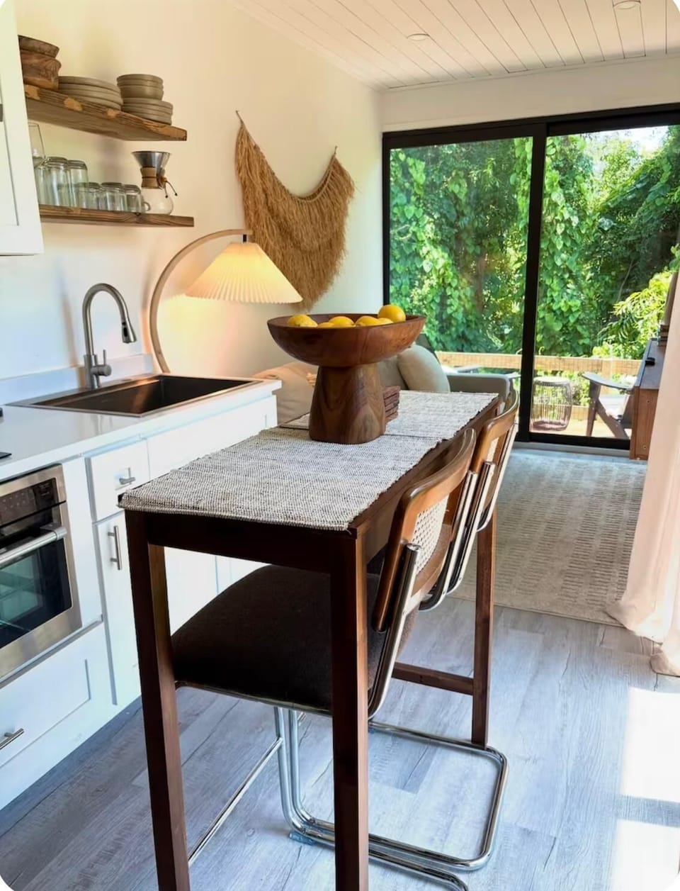 Wooden dining table. Extra foldable bar stools are provided to accommodate 4. 