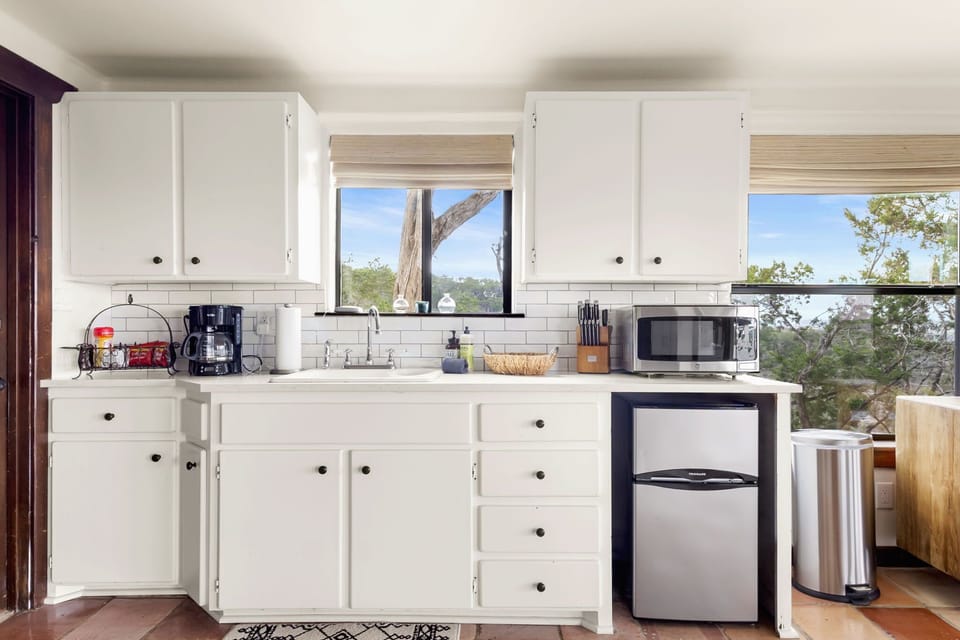 Kitchenette with a mini-fridge, microwave, and coffee maker
