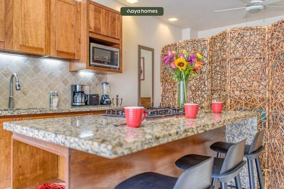 Start your day off right at this spacious granite kitchen island. Complete with comfortable bar stool seating and a built-in stovetop, it's the perfect spot to enjoy your morning coffee.