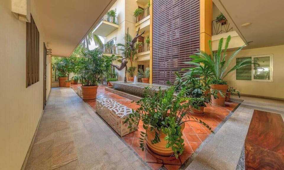 Stroll through the beautiful building grounds. This peaceful open-air courtyard is filled with vibrant tropical plants and classic tilework.