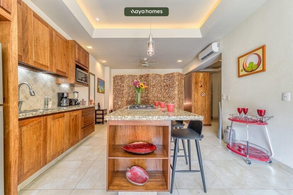 Prepare your favorite meals in this expansive, fully equipped kitchen. Featuring gorgeous custom wooden cabinetry, ample granite counter space, and modern appliances, it has everything you need to feel right at home during your stay.