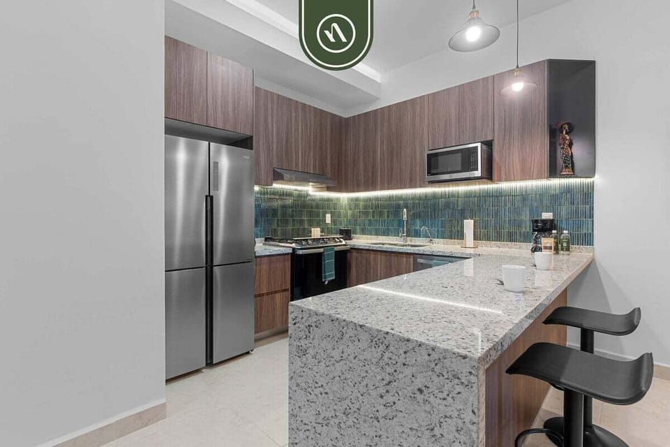 Cook your favorite meals in this stunning modern kitchen. It boasts sleek wood cabinetry, gorgeous granite countertops, and a full suite of stainless steel appliances.