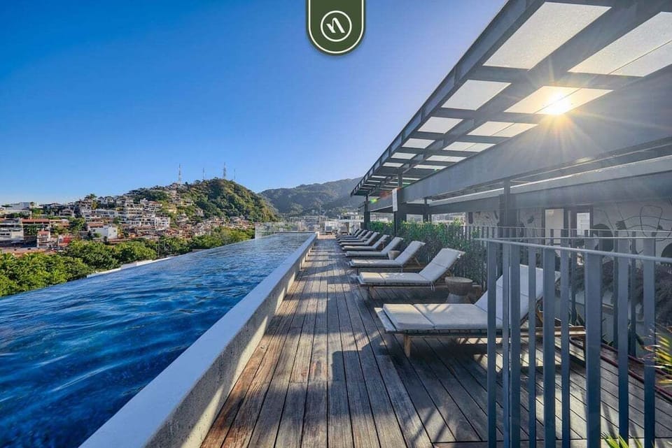 Swim and sunbathe at our spectacular rooftop deck. Enjoy the stunning lap-style infinity pool, comfortable sun loungers, and panoramic views of the hills.