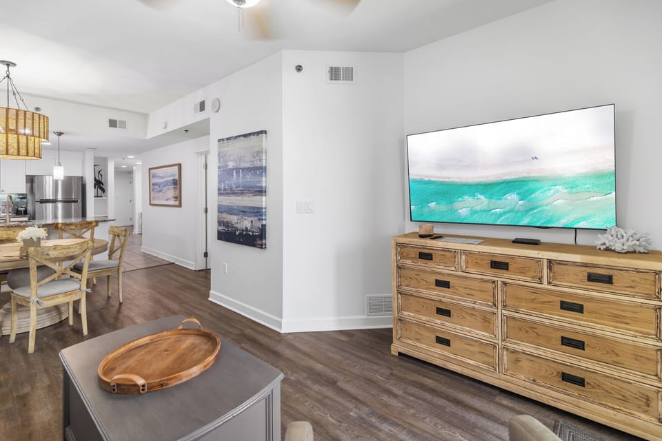 Your bright, open living space flows into the dining area and kitchen, perfect for gathering with loved ones. Coastal-inspired decor and high ceilings create a relaxed, beachy vibe.