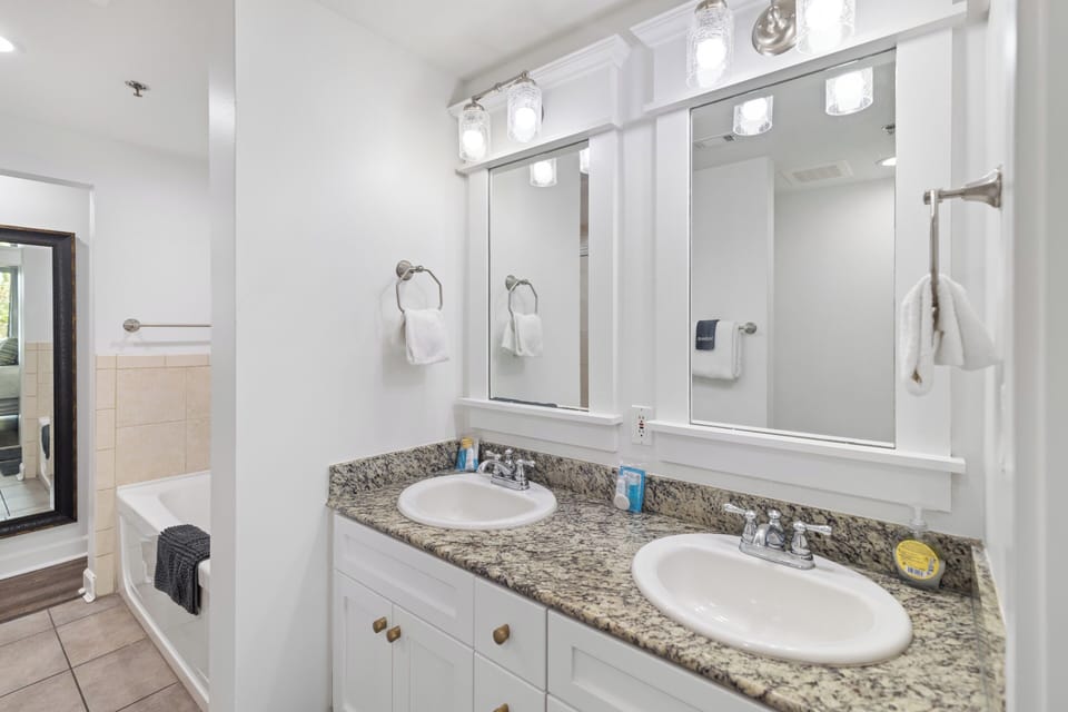 Step into your beautifully appointed bathroom with dual vanities, granite countertops, and bright lighting. Fresh towels await, and there's plenty of room to unwind after a day of adventure.