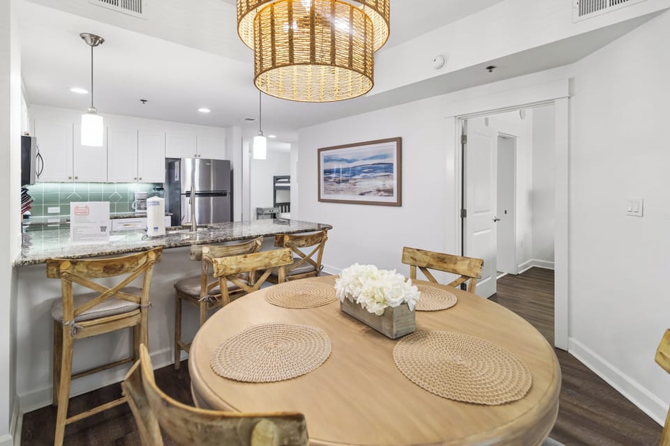 Gather around the table for meals in this bright, open dining area with coastal-inspired décor and a welcoming kitchen just steps away.