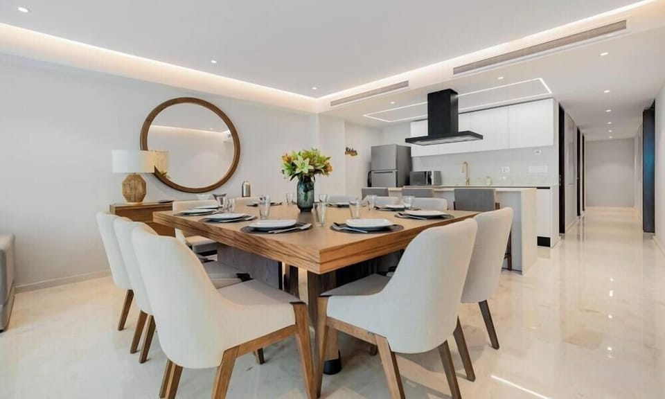 Gather around a beautifully appointed dining table in a bright, open-concept setting perfect for shared meals and entertaining.