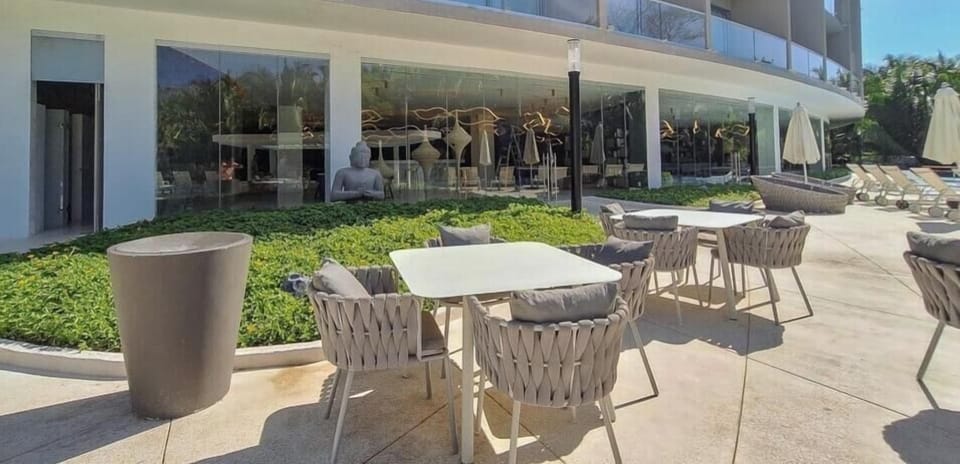 Relax and socialize in a beautifully landscaped outdoor common area with comfortable seating and a peaceful atmosphere.