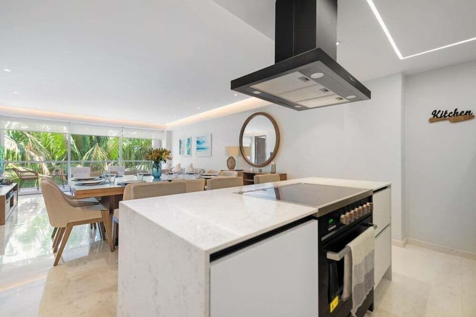 Prepare meals with ease in a modern kitchen featuring premium appliances, ample workspace, and contemporary finishes.