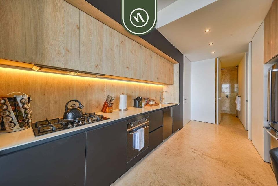 Stylish modern kitchen with high-end appliances, sleek cabinetry, and warm ambient lighting.
