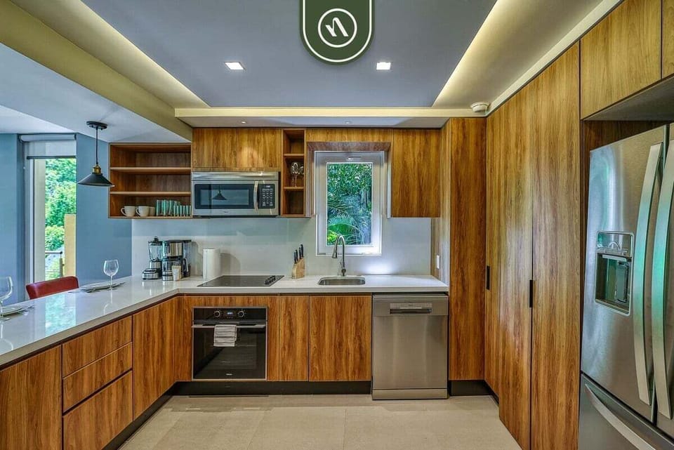 Fully equipped kitchen with custom wood cabinetry, sleek countertops, and modern appliances—perfect for cooking and gathering.