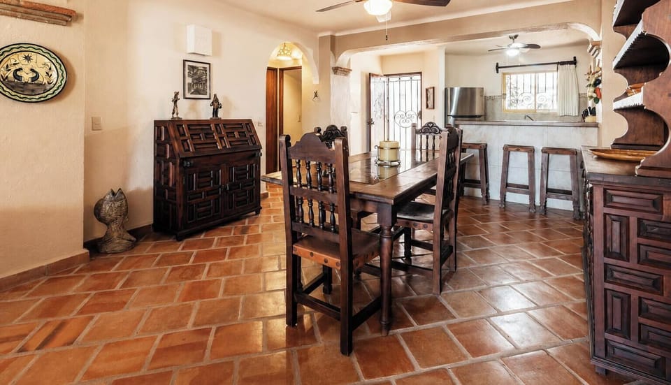 A perspective from the dining table showcasing the home's smooth open-plan connection to the kitchen and breakfast bar.