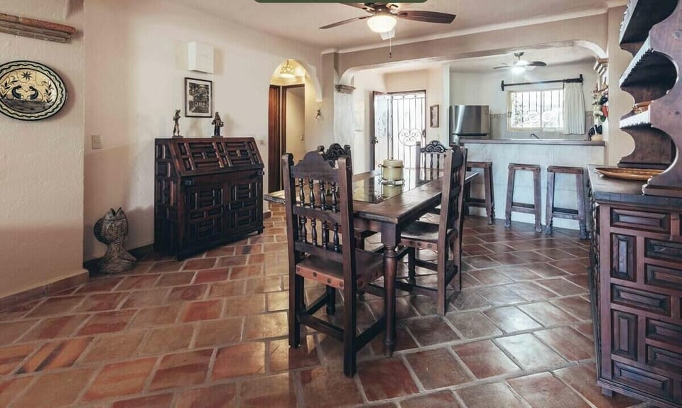 A perspective from the dining table showcasing the home's smooth open-plan connection to the kitchen and breakfast bar.
