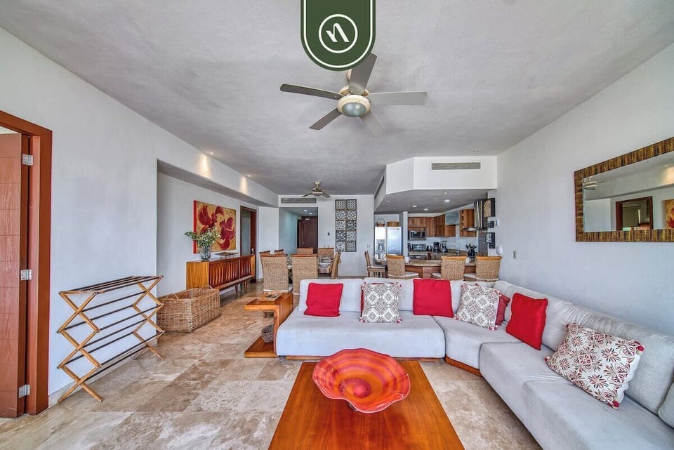 Experience true open-concept living. This bright, airy space connects the comfortable sectional seating to a full dining area and modern kitchen, perfect for group entertaining.