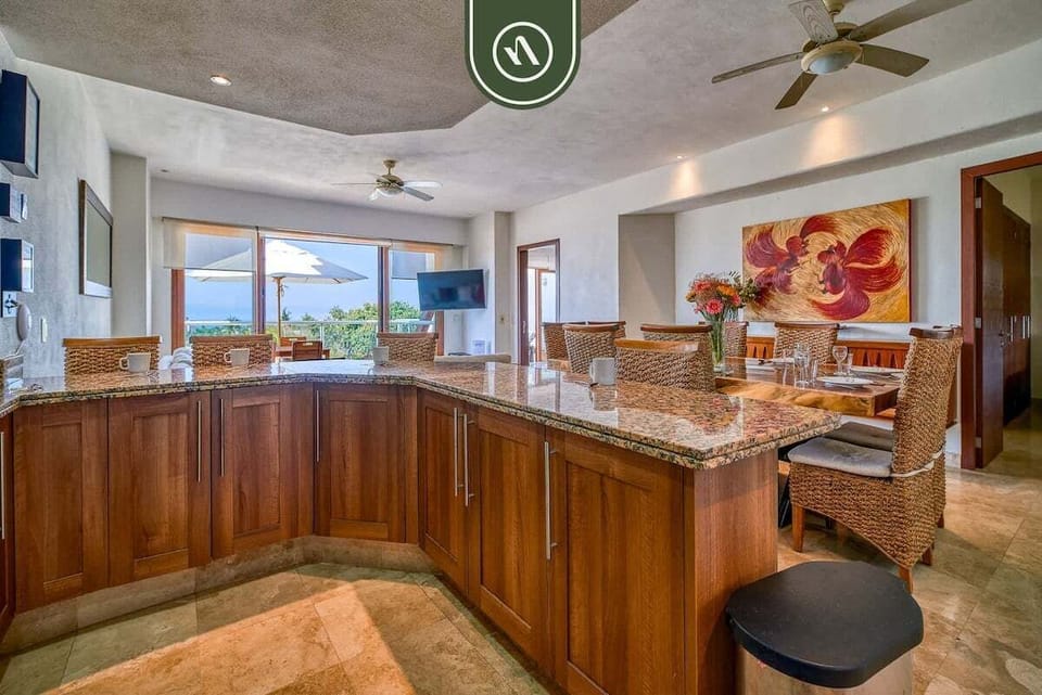This gourmet kitchen features expansive granite countertops and premium cabinetry. The open layout ensures you can stay part of the conversation while preparing meals at the bar.