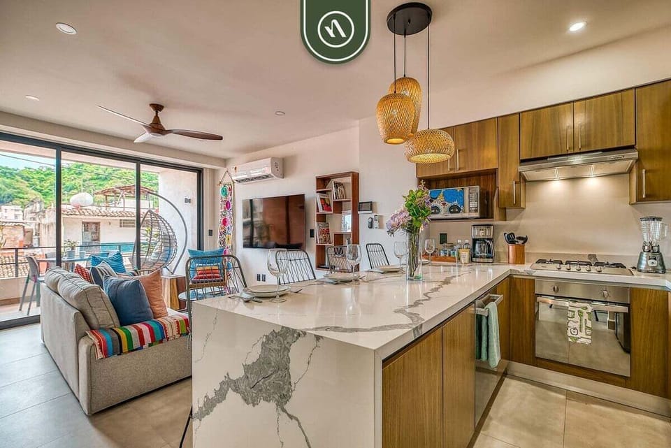 Spacious open-concept kitchen featuring a marble island and bright living space.