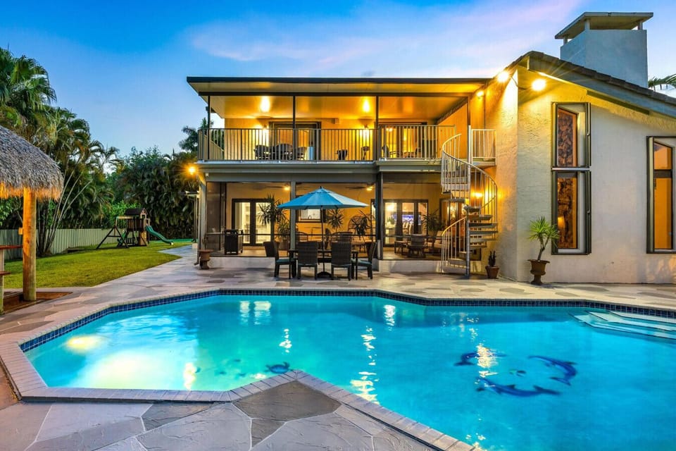 Two-story getaway with large pool, illuminated patio, and family-friendly setup