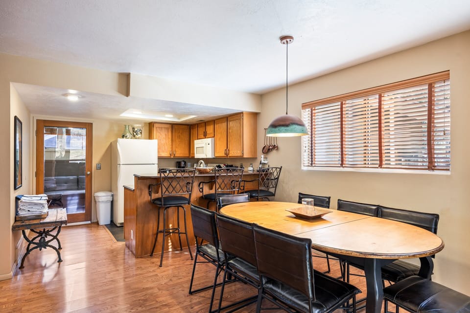 A bright, open-concept kitchen and dining space with seating for the whole group.