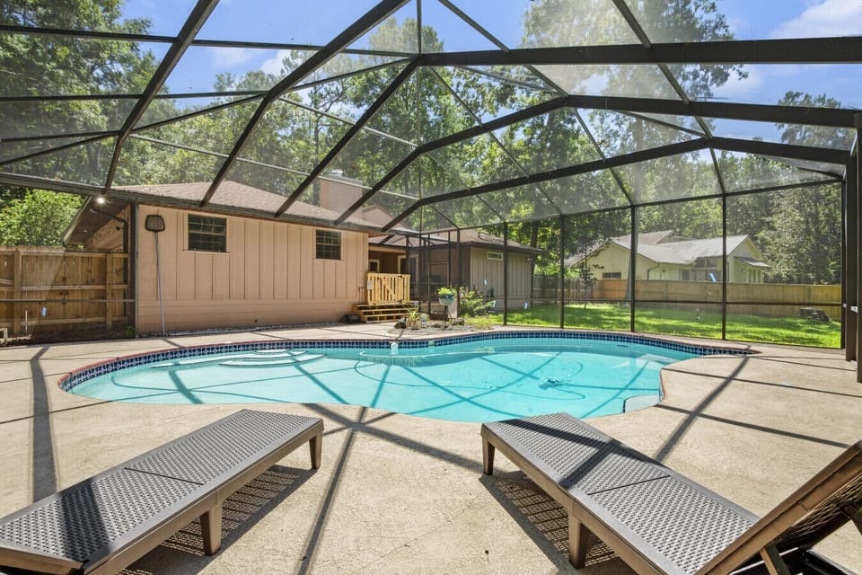 Large screen area with lounge chairs and pool