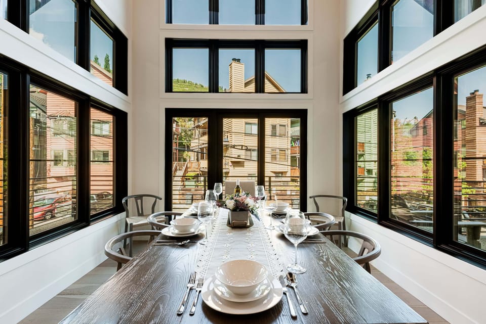 Dining Table surrounded by Floor-to-Ceiling windows