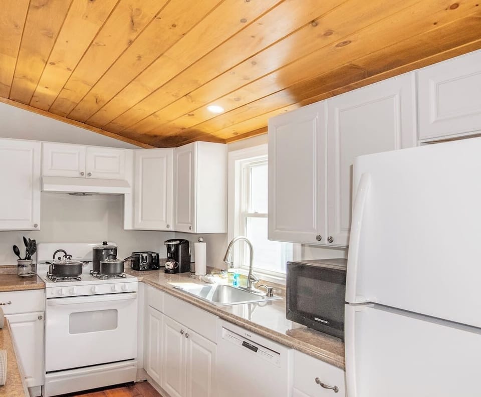 Fully stocked kitchen overlooking living room and dining room 