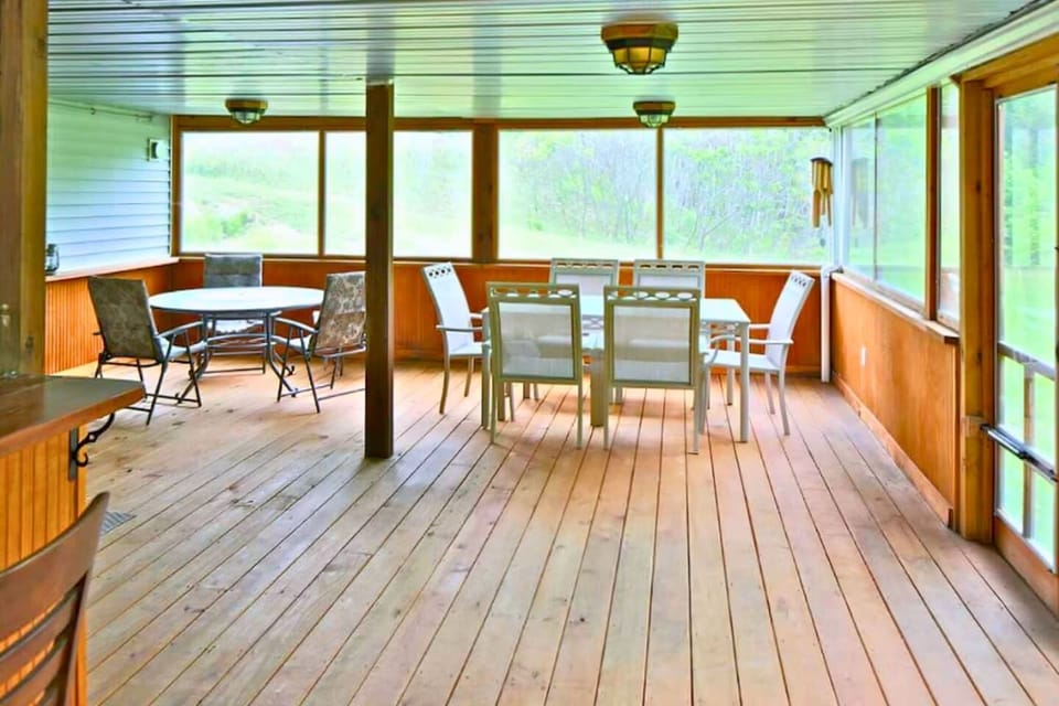 Lots of room for everyone in the enclosed porch near hot tub.