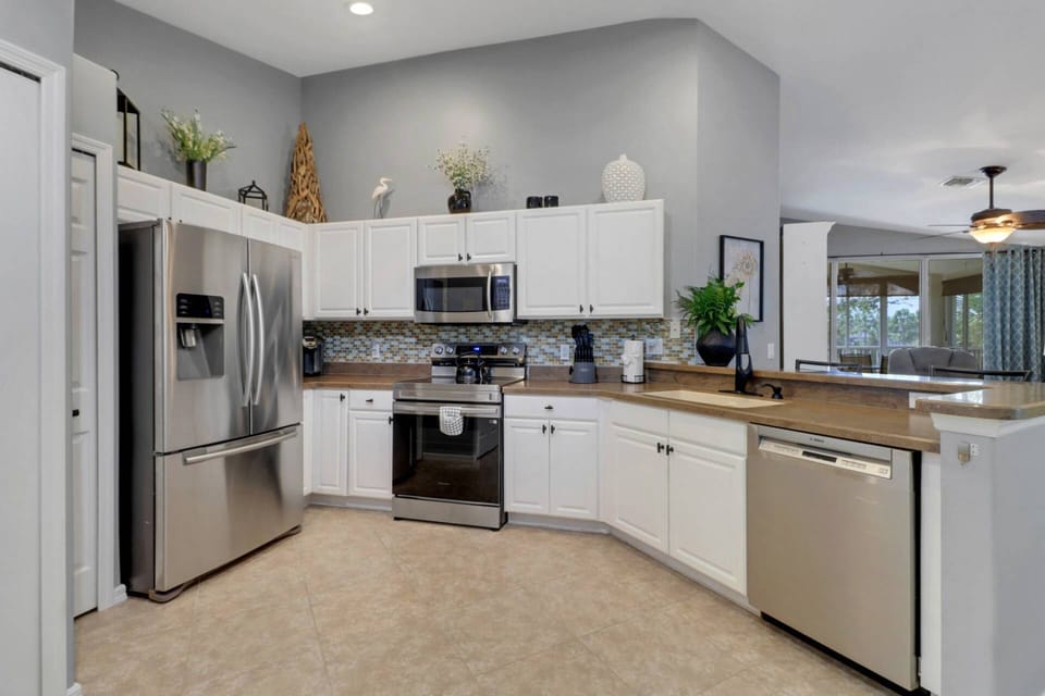 The well appointed kitchen features full size stove, microwave, refrigerator/freezer with icemaker, and dishwasher.