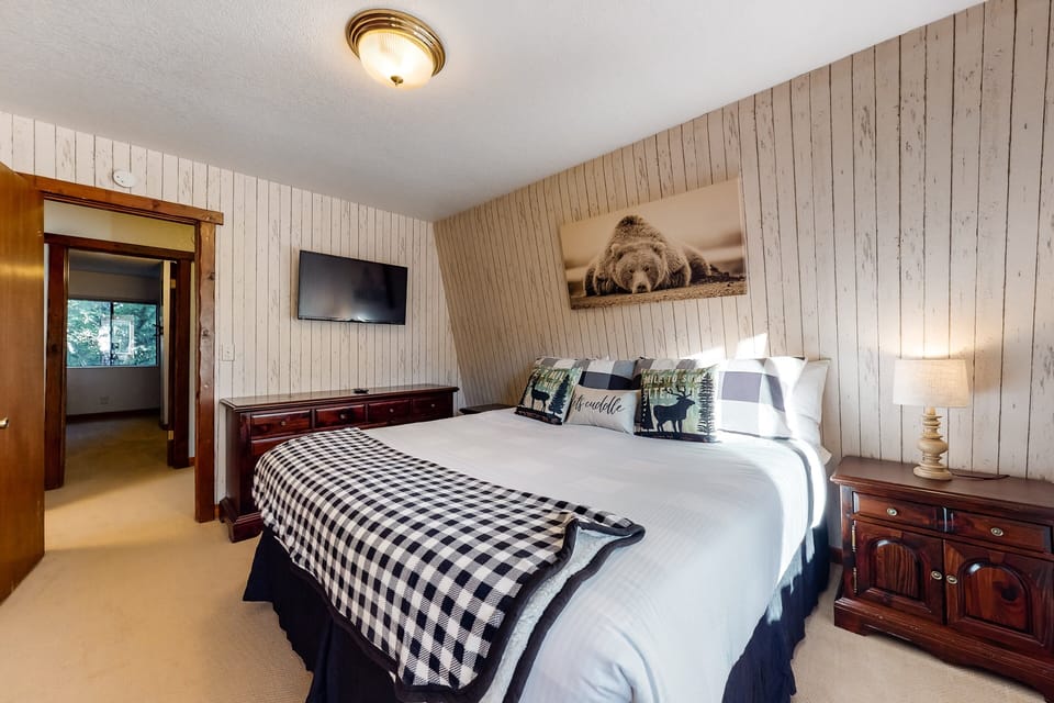 Peaceful cabin bedroom with plush bedding, and beautiful views—ideal for restful nights, cozy mornings, and a relaxing mountain escape.