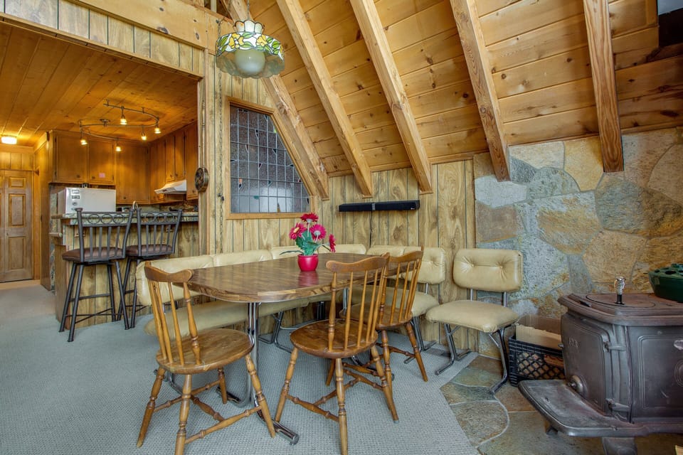 Gather around the dining table, which offers seating for four perfect for meals and game nights.