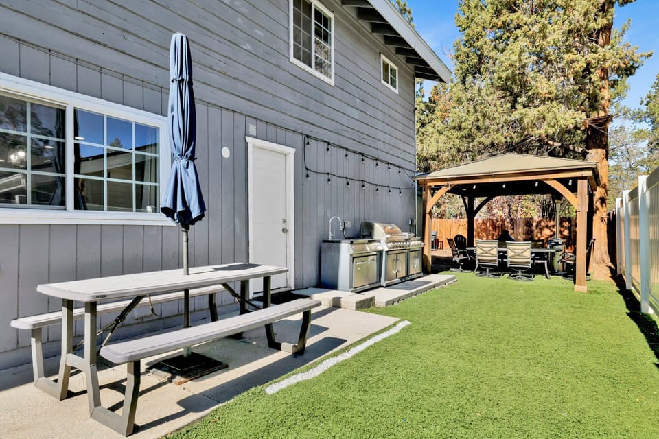 Private outdoor hot tub, surrounded by tall pines, perfect for relaxing under the trees after a day of adventure—enjoy peaceful forest views, fresh air, and a truly rejuvenating stay.