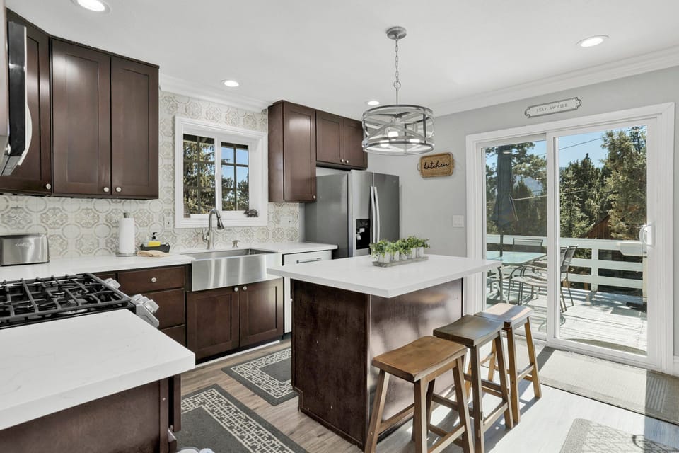 Fully equipped cabin kitchen with ample cabinetry, stove, fridge, microwave, and coffee maker—perfect for cooking meals, morning coffee, and feeling right at home on your stay.