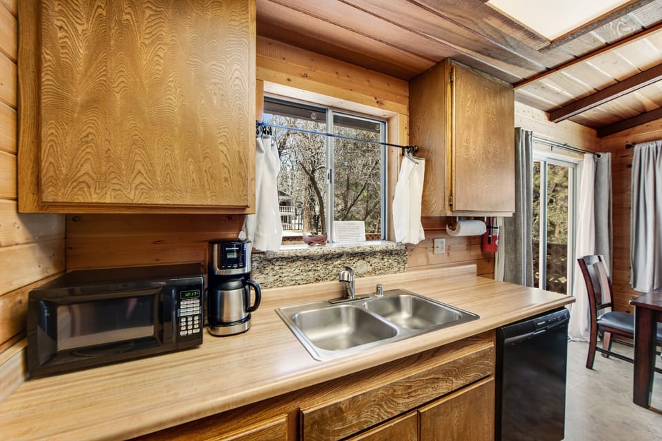 Modern kitchen with sleek counters, bright lighting, and stainless appliances.