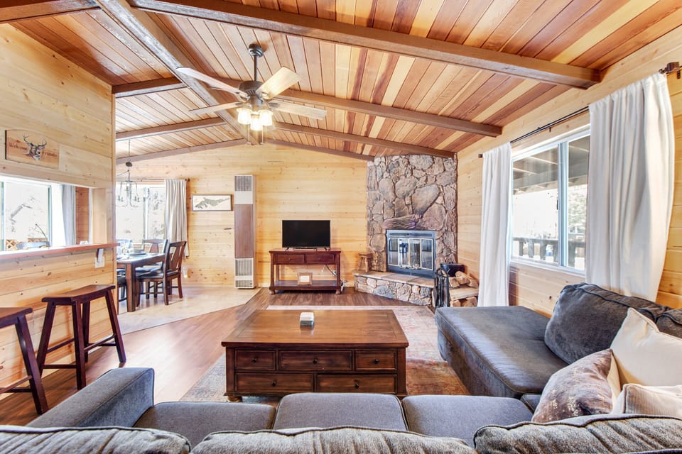Spacious living room featuring sleek furniture, soft tones, and natural light.