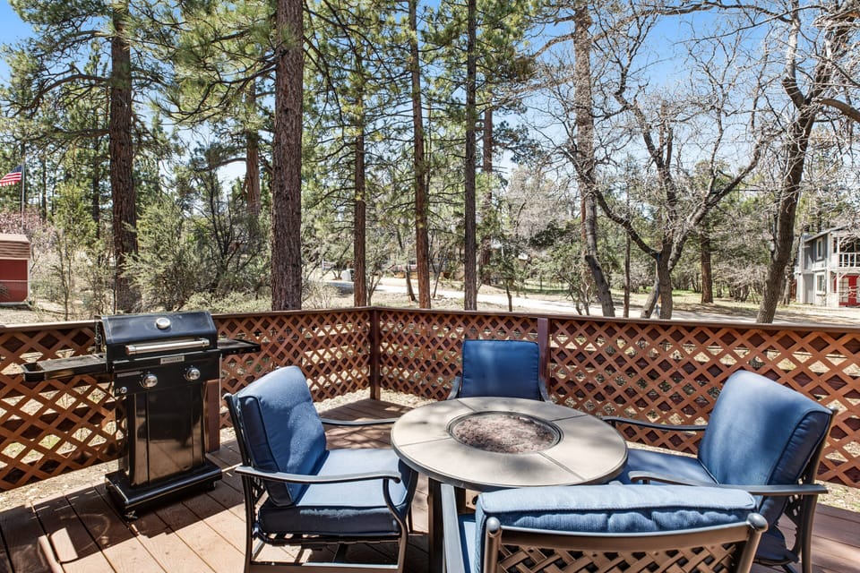 Cozy patio featuring modern grill, stylish furniture, and warm ambiance.