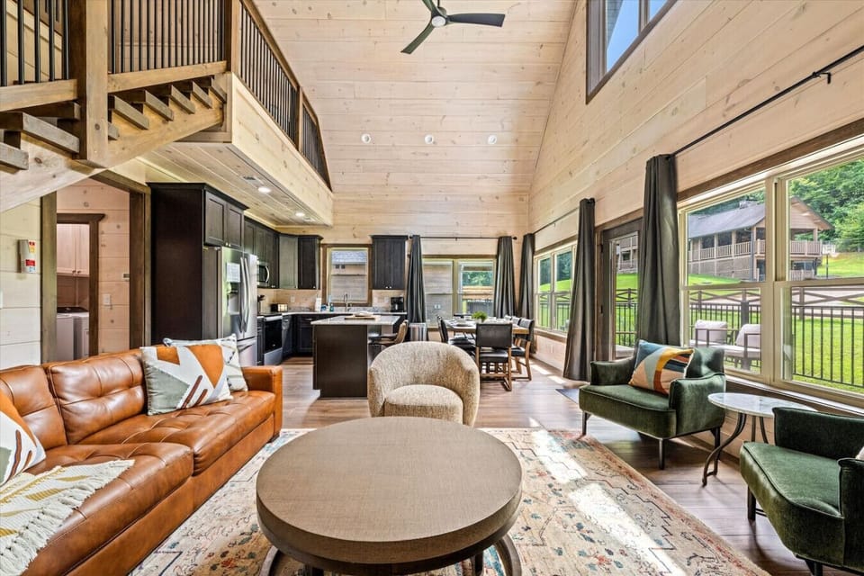 From this view, the living room flows effortlessly into the kitchen and entryway, giving the cabin an open, spacious feel while still offering cozy places to settle in after a day of adventure.