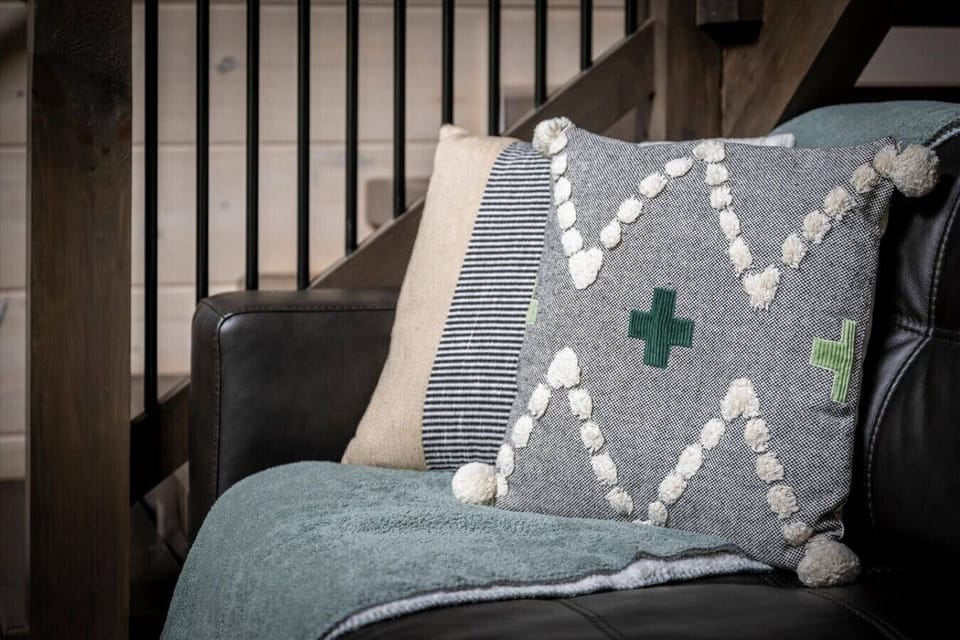 Thoughtful details, from the leather sofa to soft throws and decorative accents, make this space as comfortable as it is beautiful—an ideal retreat after a day of adventure.