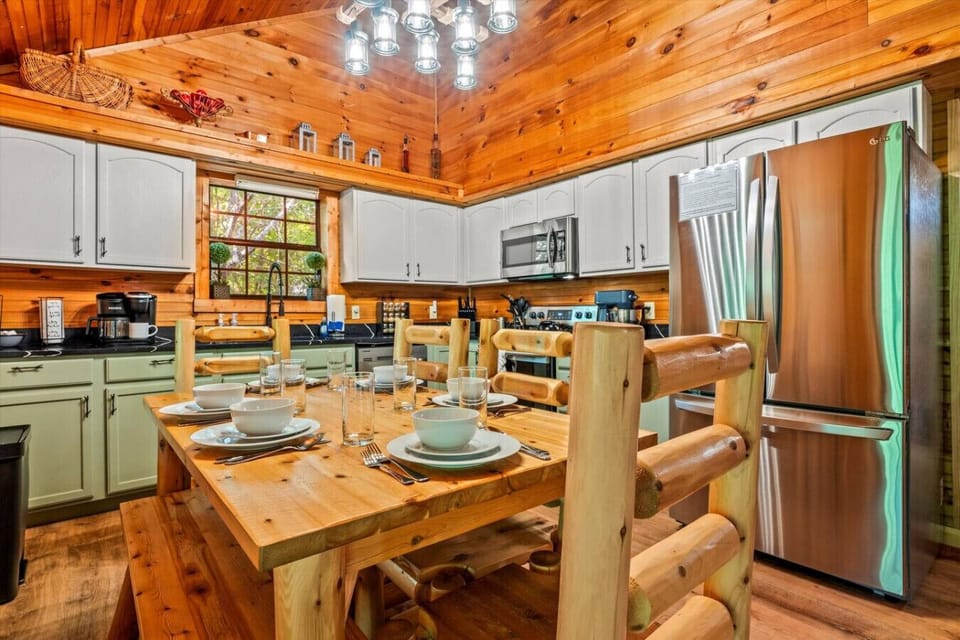 The log-style dining table, set for a family meal, invites you to gather together for home-cooked breakfasts or cozy dinners after a day in the mountains.