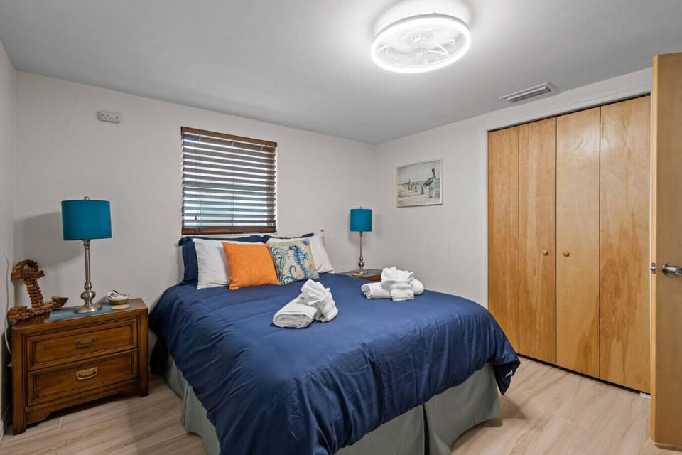 A cozy master retreat with crisp linens, vibrant pillows, and ample closet space, offering comfort after a day on the water.