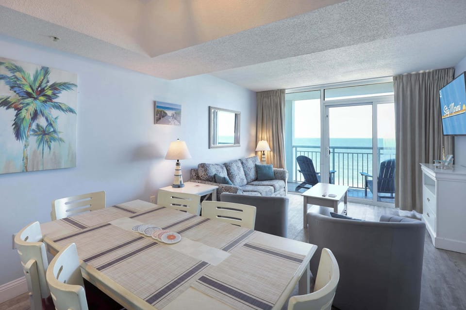 Relax in coastal comfort! This bright, beach-themed open-concept living and dining space is perfect for family gatherings, game nights, and making memories just steps from the ocean. Spacious, stylish, and fully equipped for your seaside escape!