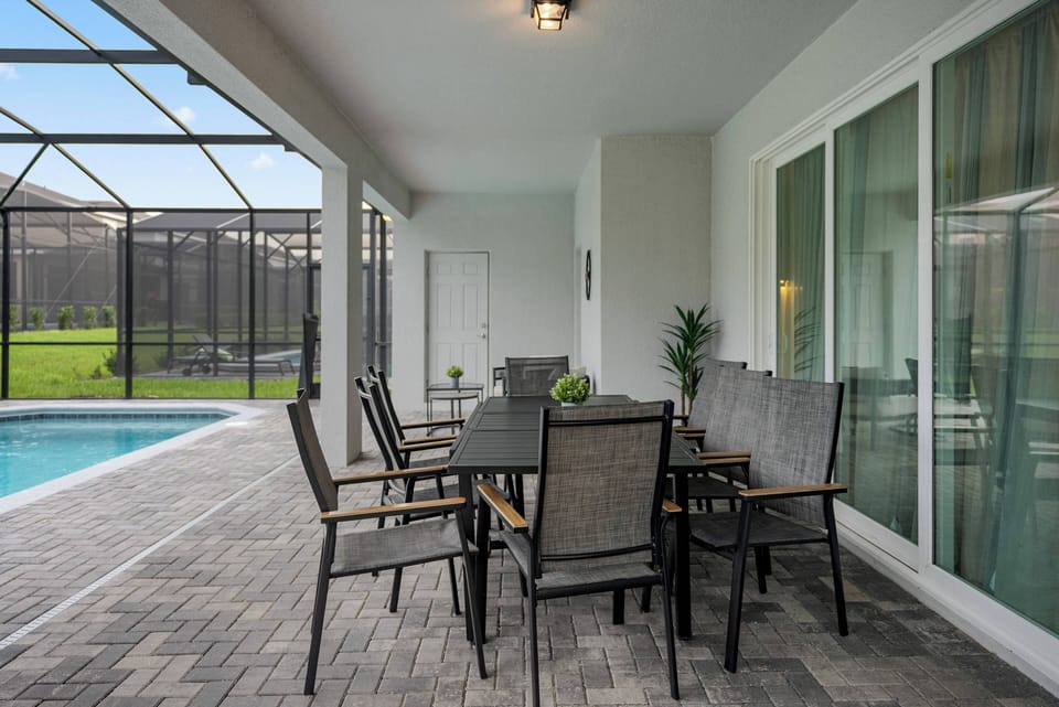 Enjoy outdoor dining at our sleek black table with comfy, weather-resistant chairs, perfect for al fresco meals. With a view of the pool and plenty of natural light, it’s a relaxing spot to unwind.