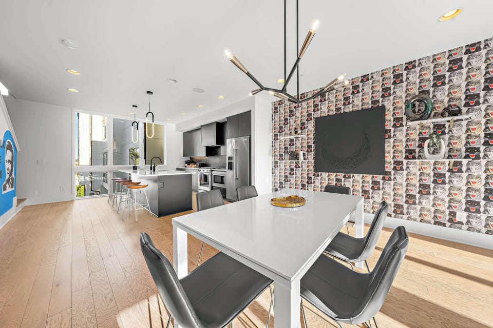 Sleek white dining table paired with modern black chairs for group meals.