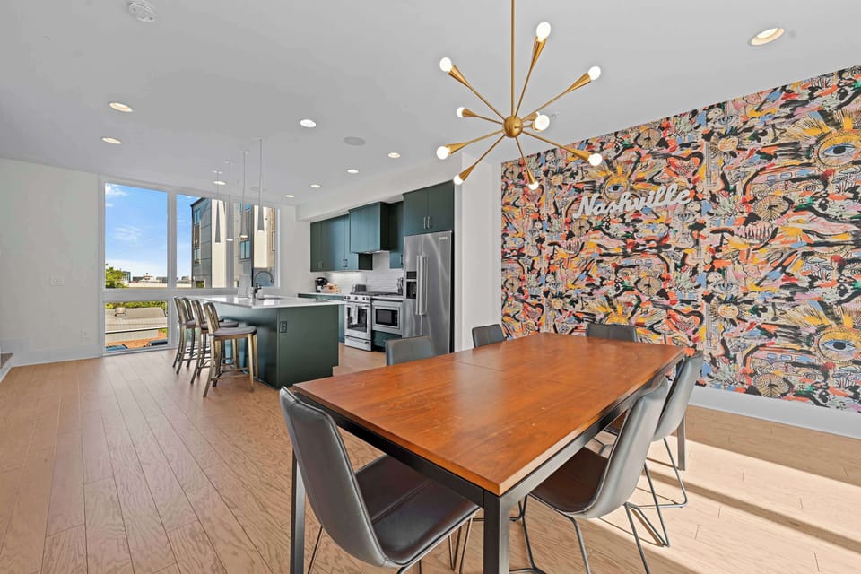 Highlights a vibrant, colorful abstract collage feature wall that adds a creative flair.