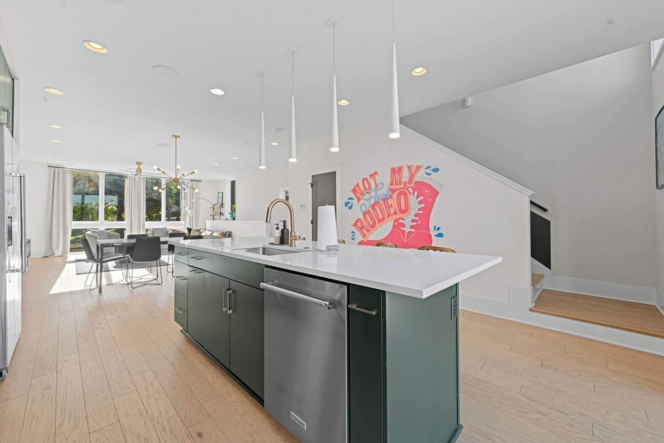 Large gourmet kitchen featuring a unique, deep forest green island base.