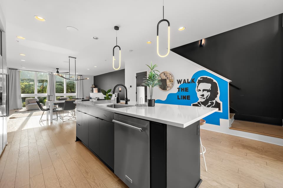 Bright, open layout lit by stunning geometric oval pendant lights.