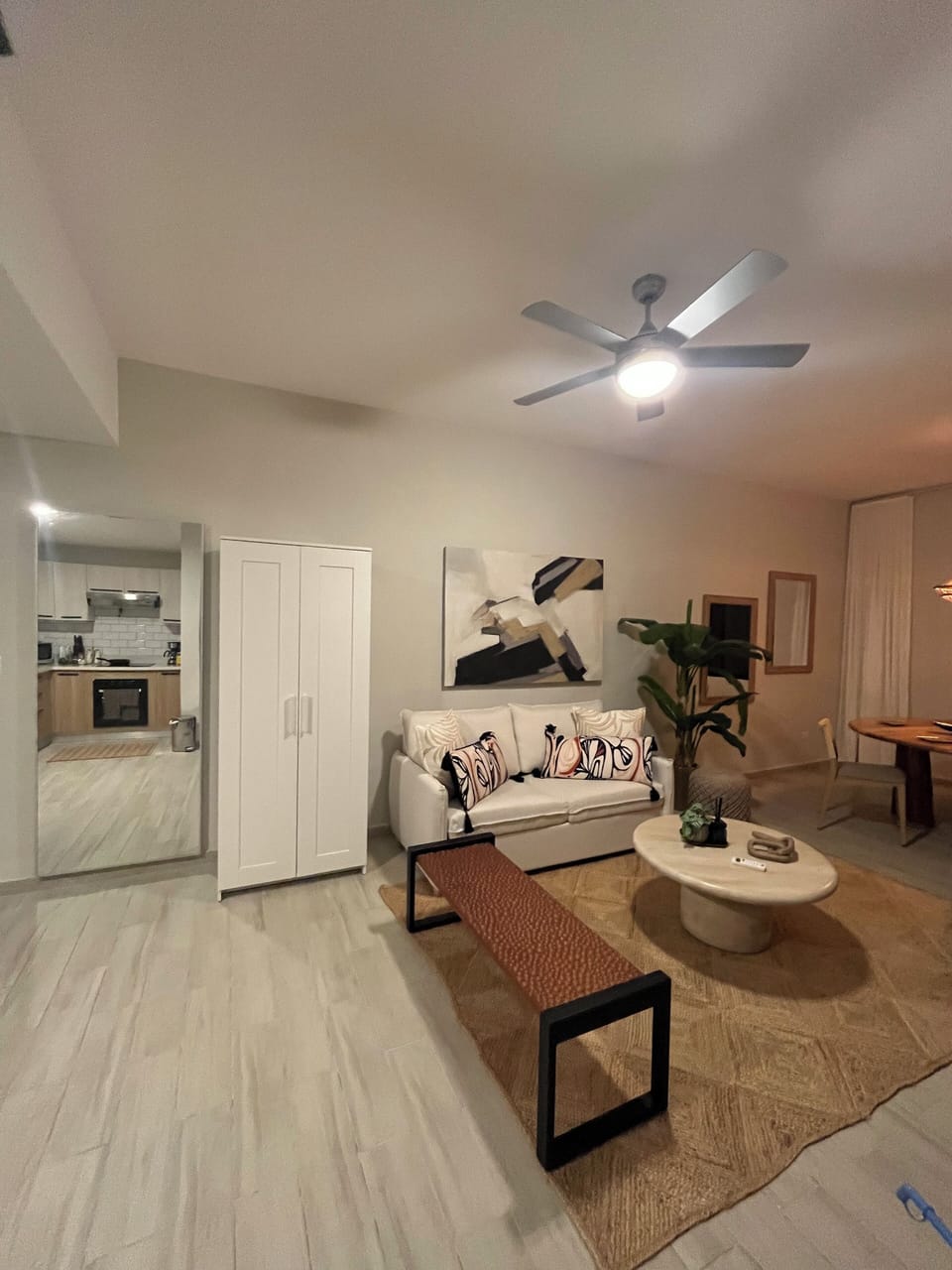 Living room with AC right next to open kitchen