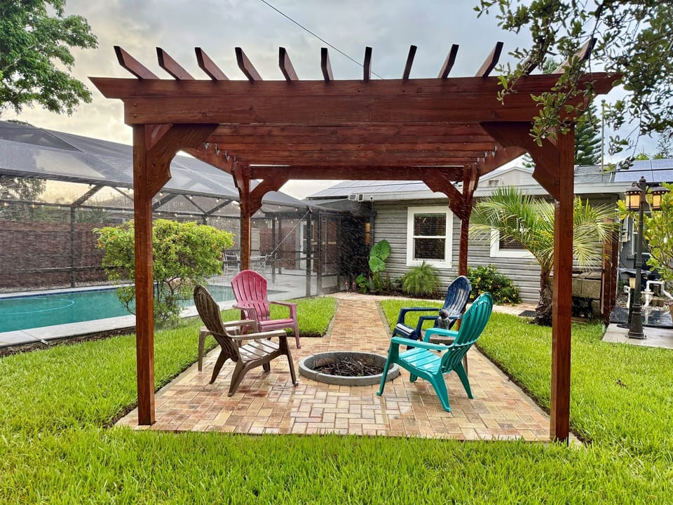 Tucked next to the pool and surrounded by palms, this peaceful pergola zone is ideal for day lounging or night gatherings.