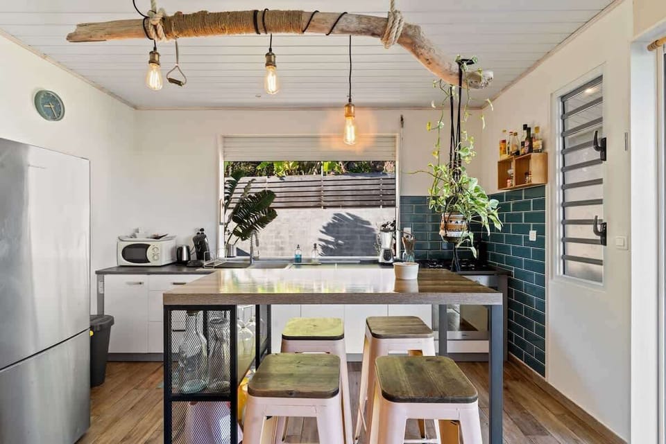 Bar island, tiled backsplash, and garden views.