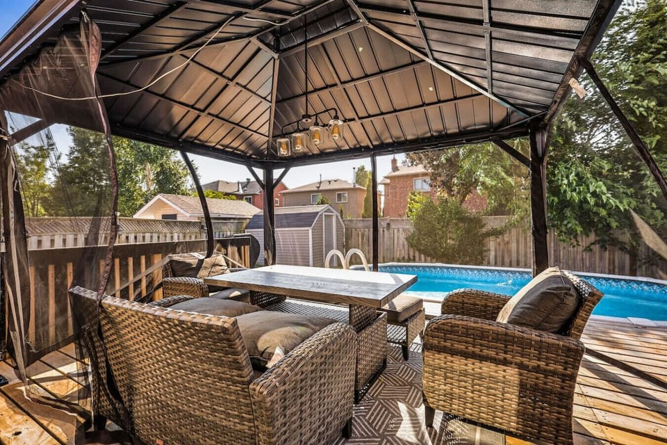 Dine al fresco by the pool. Our comfortable, shaded gazebo is the perfect spot for relaxing meals, evening drinks, or enjoying the fresh air. It offers a private, bug-free outdoor living space right off the deck.